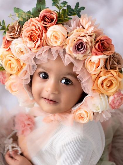 This little one looks so sweet in a beautiful floral bonnet. I have a wide variety of outfits and accessories like this to style your baby's milestone session.