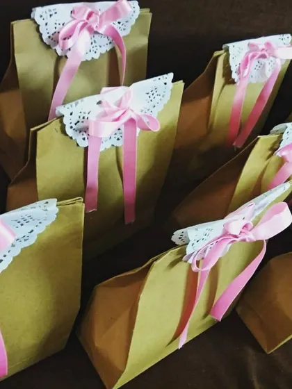 The final presentation is so important. I packed these mehendi favors in simple yet elegant paper bags, decorated with lace doilies and pink ribbons to match the event's decor.