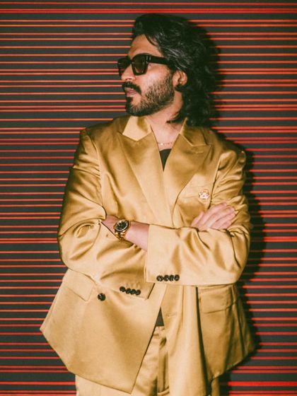 A side profile of Harshvarrdhan Kapoor, showing the movement and flow of his styled hair. This look is modern, stylish, and perfectly suited for a fashion event.