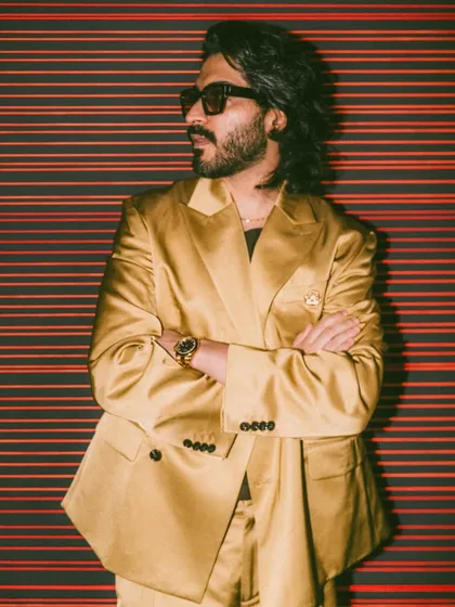 A side profile of Harshvarrdhan Kapoor, showing the movement and flow of his styled hair. This look is modern, stylish, and perfectly suited for a fashion event.