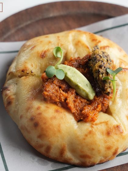 A clean, top-down shot of the Pulled Duck Kulchette, highlighting the careful placement of each component. This is a favorite from our Chef's Tasting Menu.