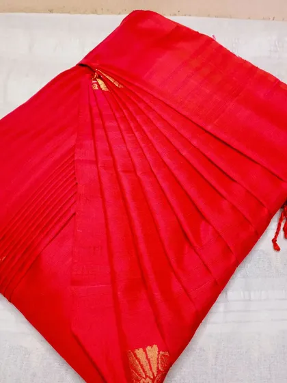 A vibrant red saree with gold motifs, pleated for a perfect drape.