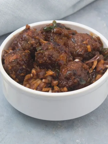 Our classic Veg Manchurian features soft vegetable balls simmered in a rich, flavourful, and tangy brown gravy. It's a perfect vegetarian main course to pair with fried rice or noodles.