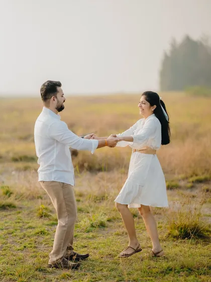 A playful and candid moment of Milan and Pranali dancing in an open field. Pre-wedding shoots are all about having fun and being yourselves.