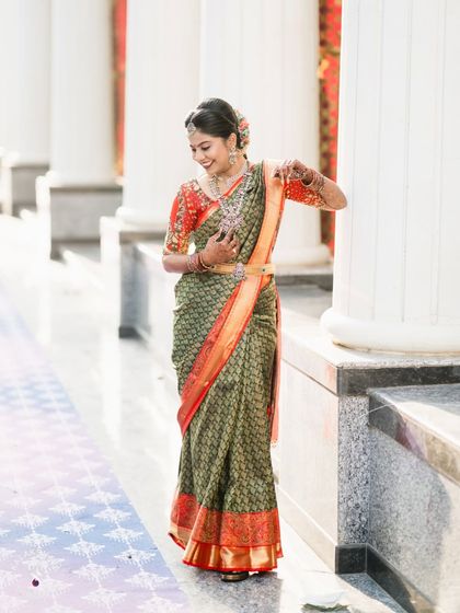 A candid shot of the bride, smiling as she walks through the wedding hall.