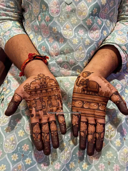 Another angle of the groom's hands, showcasing the detailed elephant and peacock designs that symbolise wisdom and beauty.