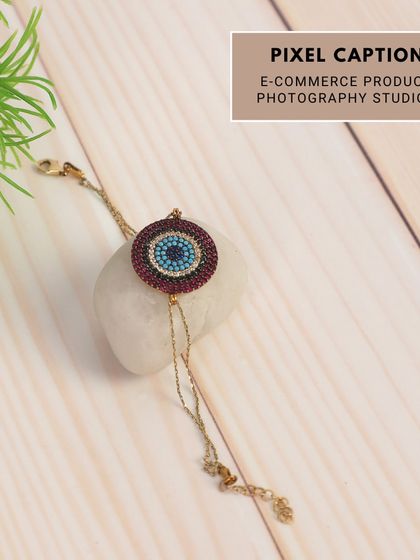 Creative product styling for an evil eye bracelet, using natural elements like stone and wood to create a lifestyle feel.