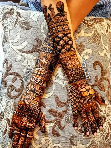 A bride deserves nothing less than perfection. This is a look at a complete bridal mehndi, featuring symmetrical patterns, traditional motifs like swans and lotuses, and intricate details covering the full arms for a truly royal look.
