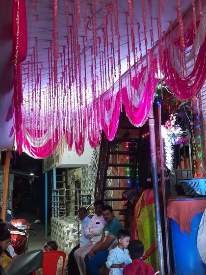 A view of the decorated ceiling and entrance area of a house Haldi function, showing how I can transform any space.