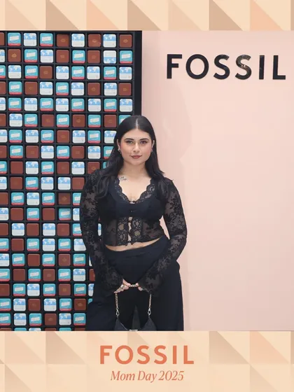 A stylish guest poses at the Fossil brand activation. The custom-branded photo overlay reinforces the brand's identity in every picture shared by attendees.