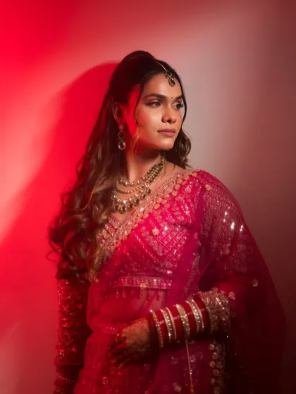 Draped in power and grace. This portrait uses bold red lighting to create a modern, fashion-inspired bridal shot.