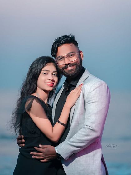 A stylish and modern portrait on the beach. The couple's coordinated outfits and confident pose make for a chic and memorable pre-wedding photo.