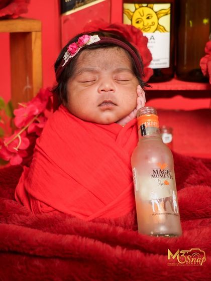 Another shot from the quirky beverage-themed session, this time with a "Magic Moments" bottle. It's all in good fun and creates memorable photos.