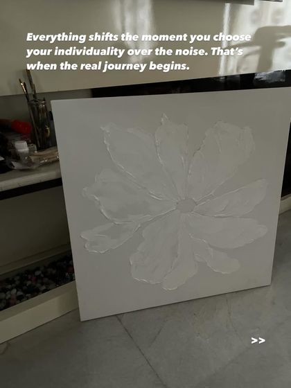 A work-in-progress shot of a textured flower on a plain white canvas. This image captures the idea that everything shifts the moment you choose your individuality over the noise. That's when the real journey begins.