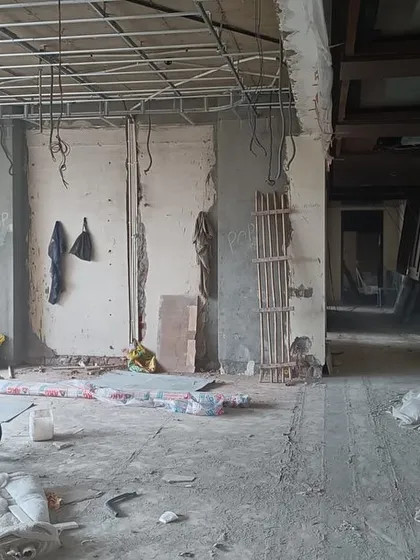 This is the "before" shot. A raw, empty construction site, filled with debris and exposed wiring, holds all the potential for the beautiful, calm, and timeless home it is about to become.