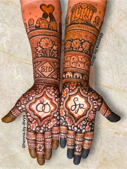 A personalized engagement mehendi featuring the couple's initials 'SP' and 'SID' in stylish fonts. The design also includes engagement rings, a couple silhouette, and love birds.