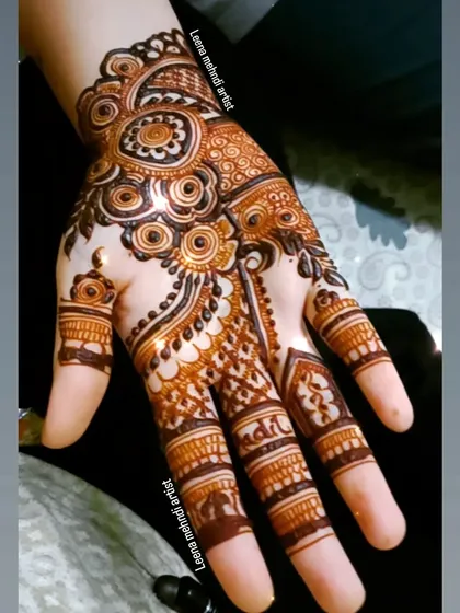 A beautiful Arabic-style design for a guest. The pattern is intricate and flows nicely on the hand, combining floral and geometric elements.