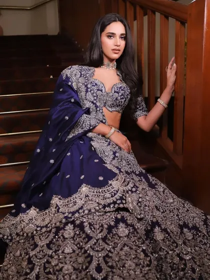 The rich blue fabric and detailed silver work create a stunning contrast, making this a memorable and elegant choice for an evening event.