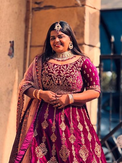 The rich purple velvet and intricate gold embroidery on this bridal lehenga make it a perfect choice for a winter wedding. It’s both warm and incredibly stylish.