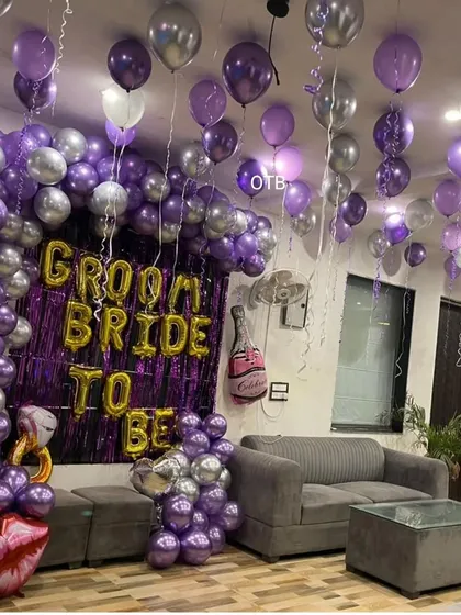 A fun 'Groom Bride to be' setup for a combined pre-wedding party. The purple and silver color scheme is unique and celebratory.