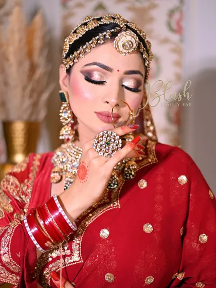 The confidence in her work is visible. This student created a beautiful soft glam bridal look with flawless skin and elegant jewelry.