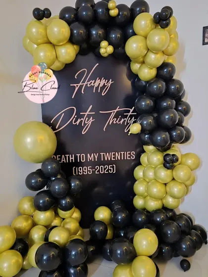 A bold 'Happy Dirty Thirty' backdrop with a black and lime green balloon garland to celebrate a 30th birthday.