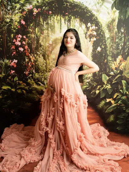 A full-length portrait showcasing a stunning ruffled gown against a garden backdrop. This pose is designed to be powerful and elegant.