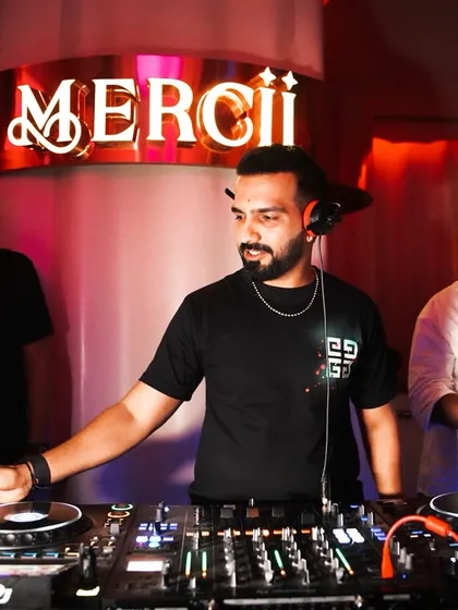 A focused shot of me at Mercii, with my headphones on, getting ready to mix in the next track.