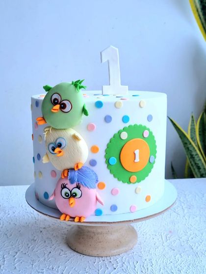 A full view of the Angry Birds cake on its stand.