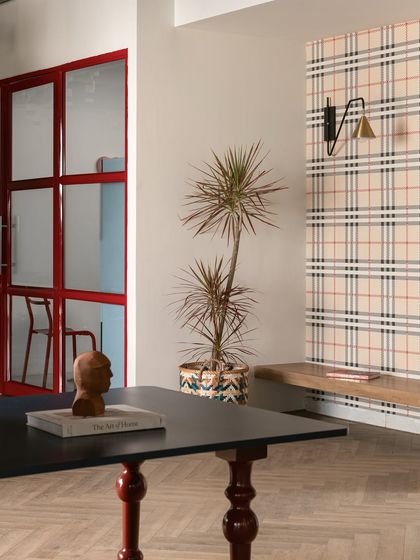 This image shows the confluence of three zones: the material island for exploring samples, the reading niche for quiet moments, and the pantry for breaks. Each space is practical yet tied together by a cohesive design language.