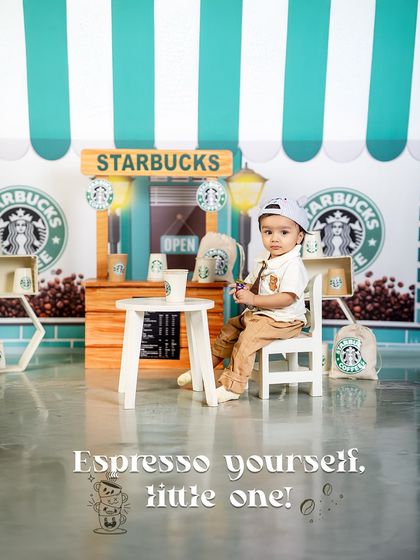 Espresso yourself, little one! This charming photo captures the fun and creativity of the Starbucks barista theme, a unique way to celebrate your little one's personality.