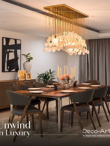 The perfect balance of modern aesthetics and luxurious details. This dining room features a stunning shell-like chandelier, abstract art, and sleek chairs, creating a space to unwind in luxury.