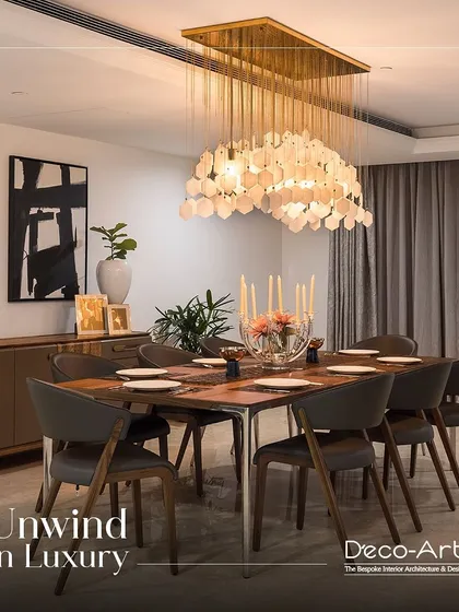 The perfect balance of modern aesthetics and luxurious details. This dining room features a stunning shell-like chandelier, abstract art, and sleek chairs, creating a space to unwind in luxury.