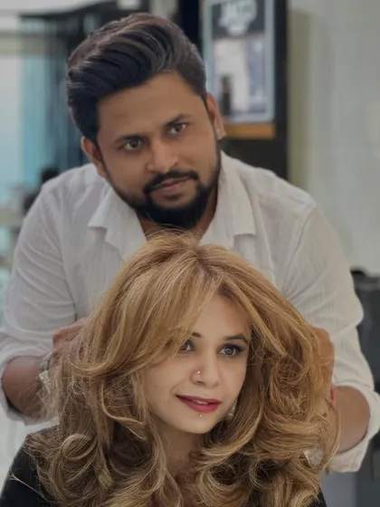 A shot of me with the client, both of us happy with her new blonde look. The color is fresh and vibrant.
