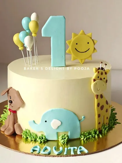 An adorable and minimal first birthday cake with cute animal friends. This design features a friendly dog, elephant, and giraffe alongside a smiling sun, all handcrafted from fondant.