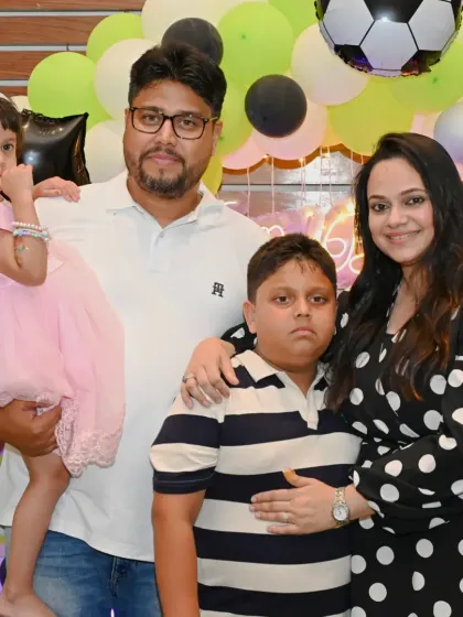 A happy family portrait at an Arsenal-themed birthday party. We create a fun environment for families to celebrate together.
