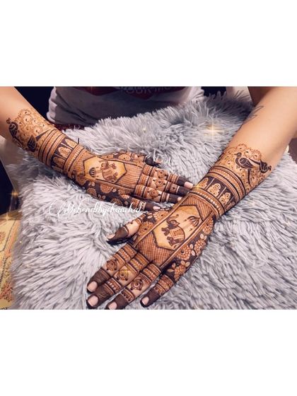 A full view of both arms, showing the complete design for the housewarming ceremony. The work is intricate and celebratory.