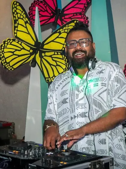 In my element, mixing tracks and watching the crowd respond. A great, clear shot of me at the DJ console, focused on delivering the perfect beat for the party.