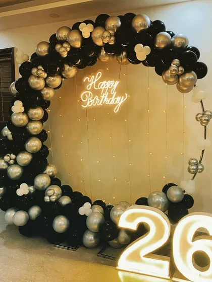 This view shows the black and silver balloon ring with fairy lights in the background for an extra sparkle.