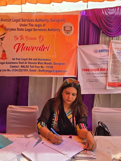 At my desk at the DLSA legal aid stall during Navratri at Sheetla Mata Mandir. It is a privilege to use festive occasions to connect with the community and offer free legal assistance.