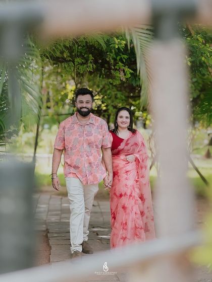 A beautiful walking shot, framed by a part of the garden structure. This adds depth and a sense of discovery to the image.