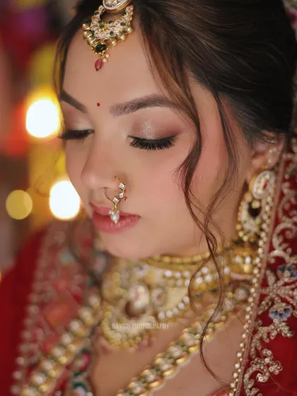 A serene bridal portrait with the bride's eyes closed, highlighting her flawless makeup and the peaceful moment before the wedding festivities.