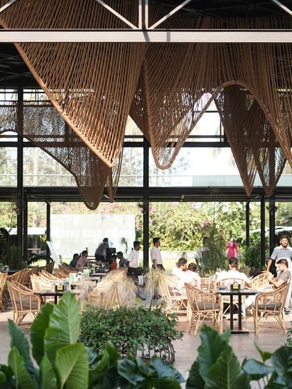 The main dining hall, with its beautiful woven ceiling and rattan chairs, is always buzzing with happy guests.
