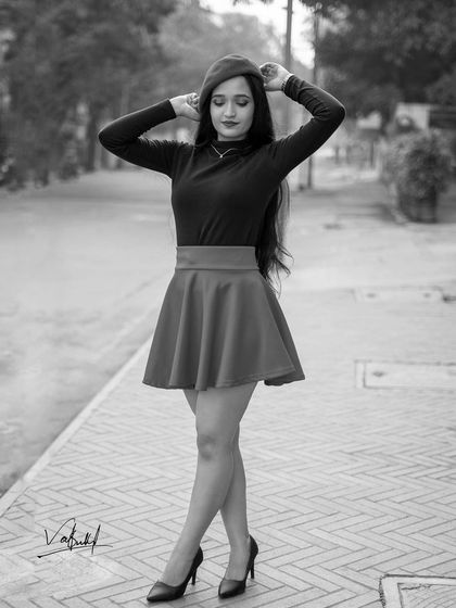 A timeless black and white edit from the Parisian-themed shoot. This monochrome version emphasizes the classic silhouette of the outfit and the model's elegant pose.