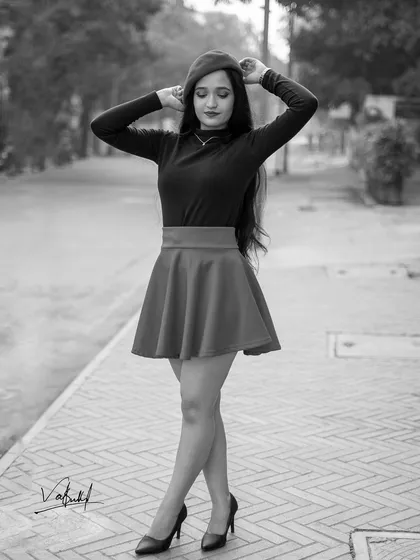 A timeless black and white edit from the Parisian-themed shoot. This monochrome version emphasizes the classic silhouette of the outfit and the model's elegant pose.