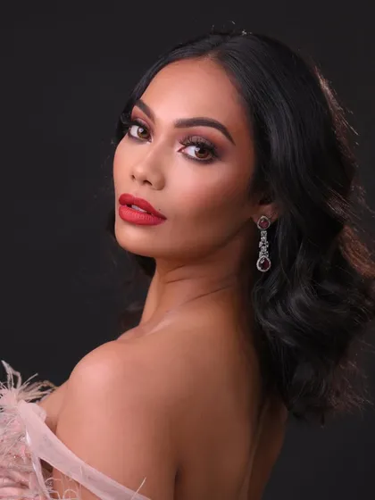 A glamorous evening look with a bold red lip and soft waves. This is a classic style every artist needs to master.
