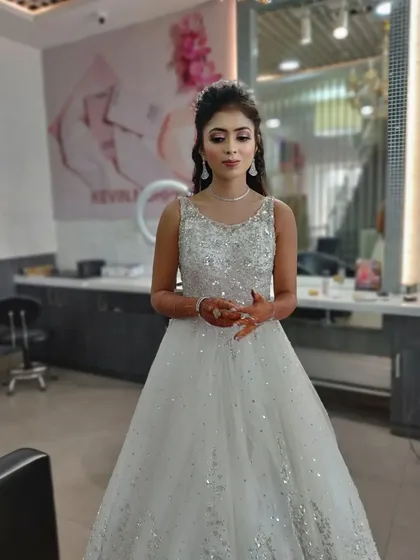A stunning reception or engagement look in a white, sequined gown. I created a glamorous look with smokey eyes, contoured cheeks, and a half-up hairstyle with a tiara for a modern princess vibe.