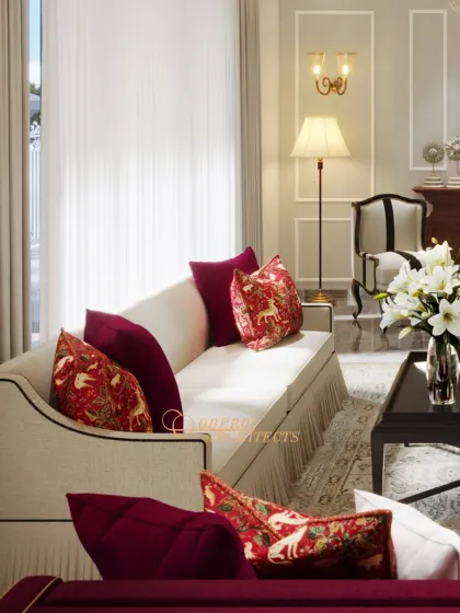 A living room that exudes traditional luxury with its rich red fabrics, classic furniture silhouettes, and ornate details.