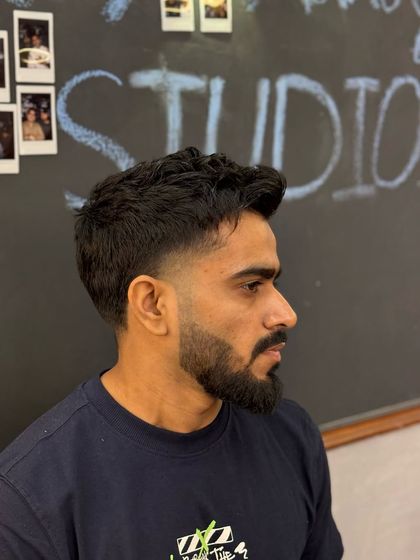 A side profile view of a classic taper fade. You can see the clean lines and the gradual blend, which gives the haircut a sharp yet natural finish.