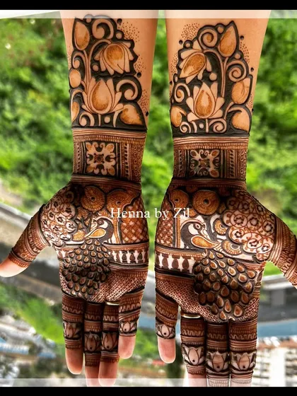 A bold and beautiful design with large peacocks on the palms and lotus motifs on the arms.